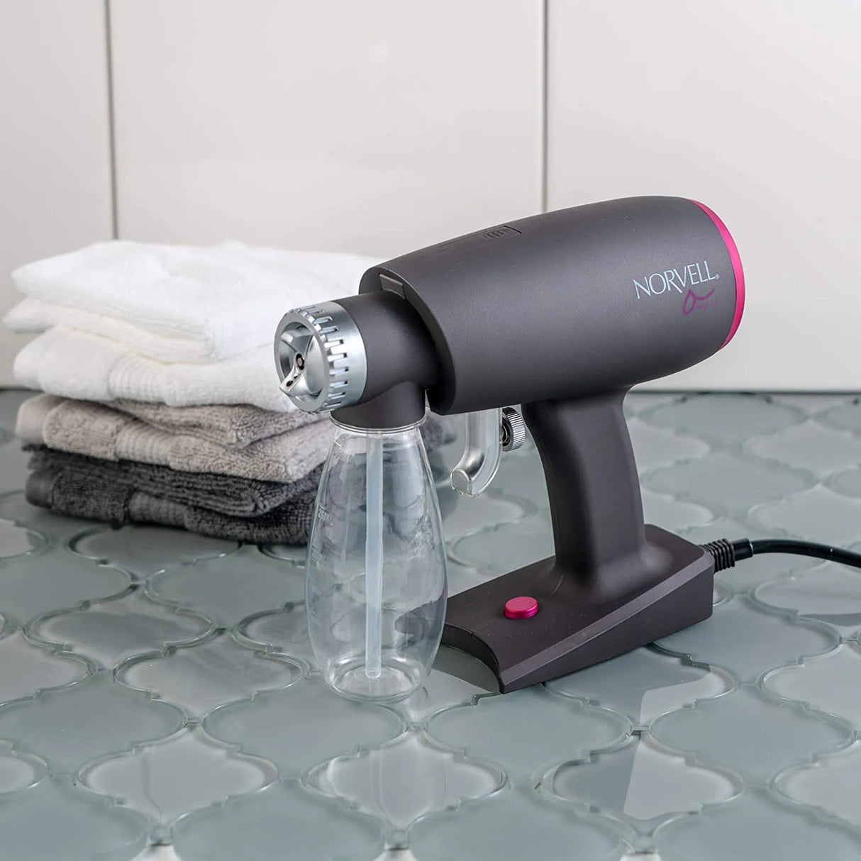 Lifestyle image of the Norvell Oasis Portable Spray Tan Gun.