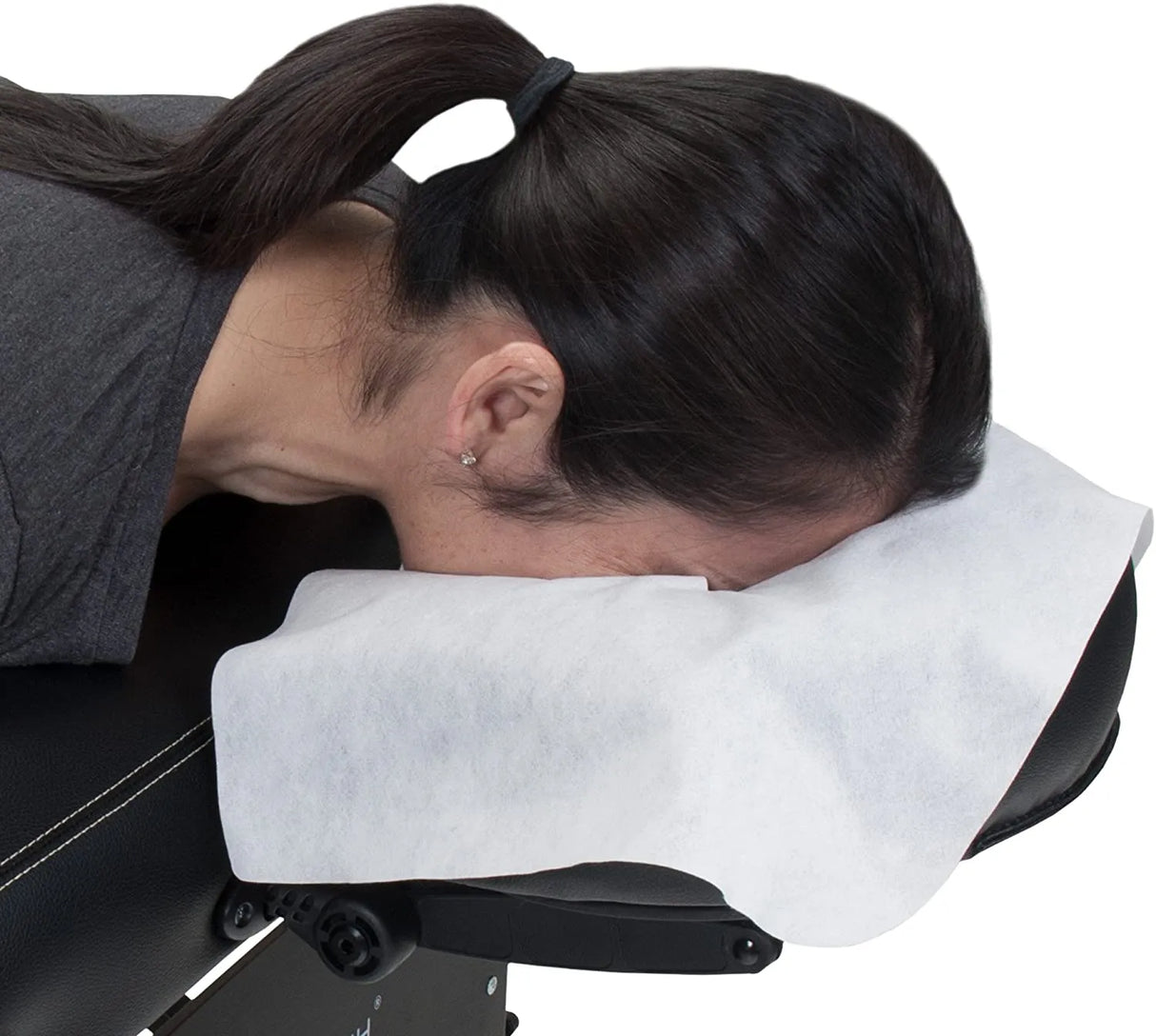 Model uses NudeU Disposable Face Cradle Covers on massage bed.