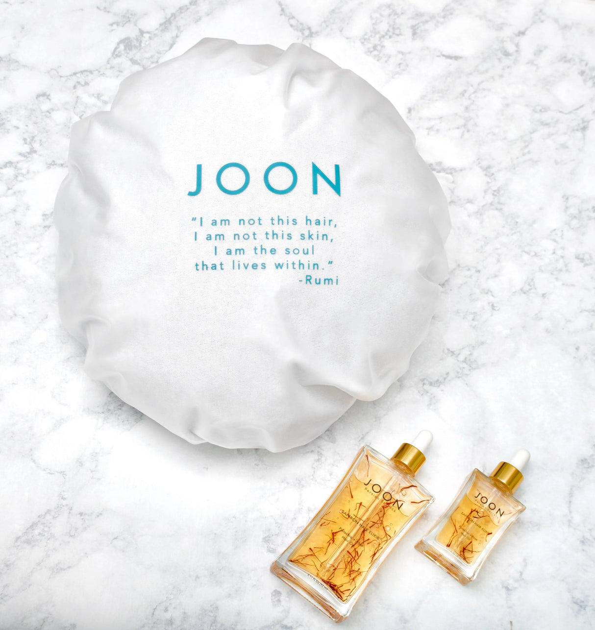 LIfestyle image showcasing JOON shower cap with other JOON family products.