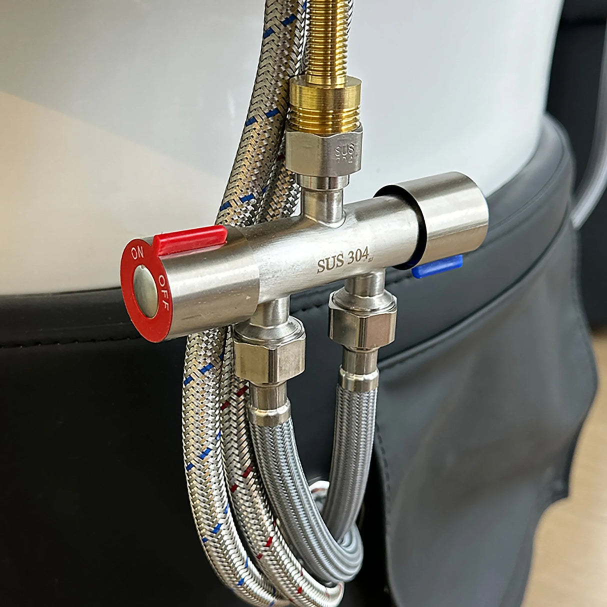Detail image of the plumbing valve on the black SSW 611-1D Fresh Water Japanese Head Spa Massage Bed