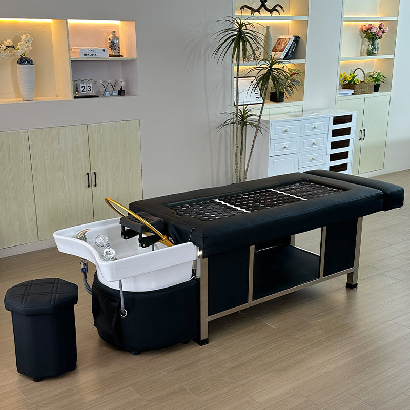 Lifestyle image of the black SSW 611-2D Fresh Water Japanese Head Spa Massage Bed in a salon.
