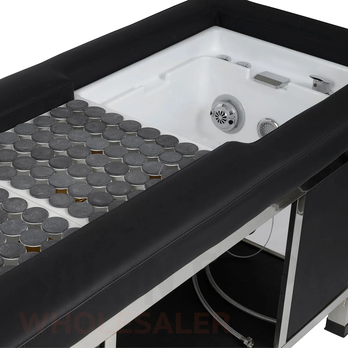 Detail image of the hot stones and foot basin on the black SSW 611-4 Japanese Head Spa Massage Bed.