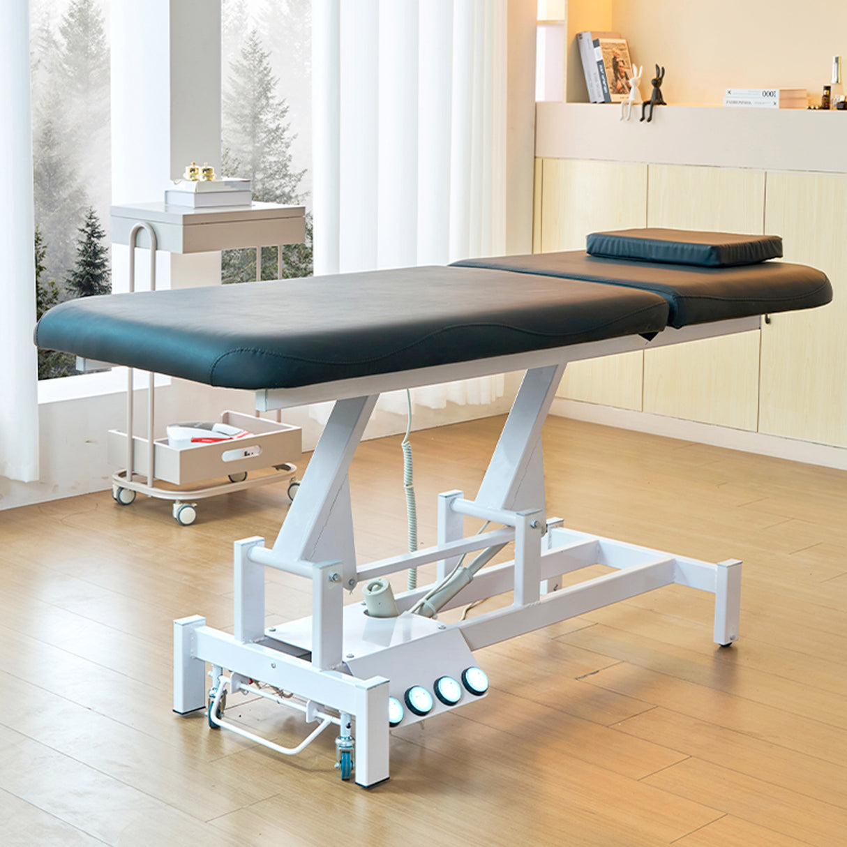Image shows the black SSW 813 Electric Treatment Table raised up.