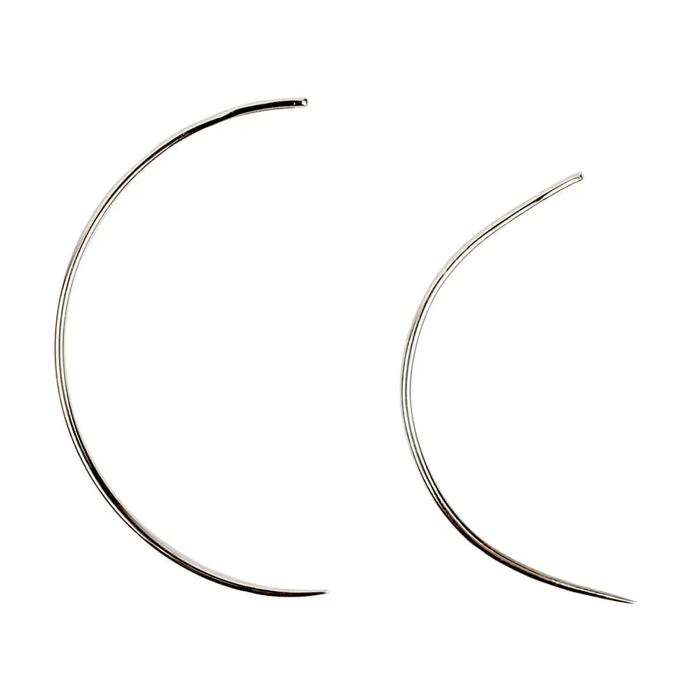 Two curved hair extension needles on a white background