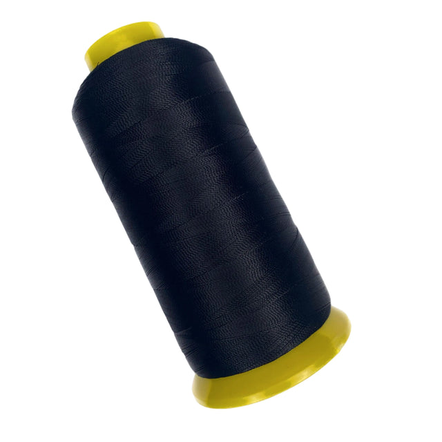 Spool of black thread with yellow ends on a white background