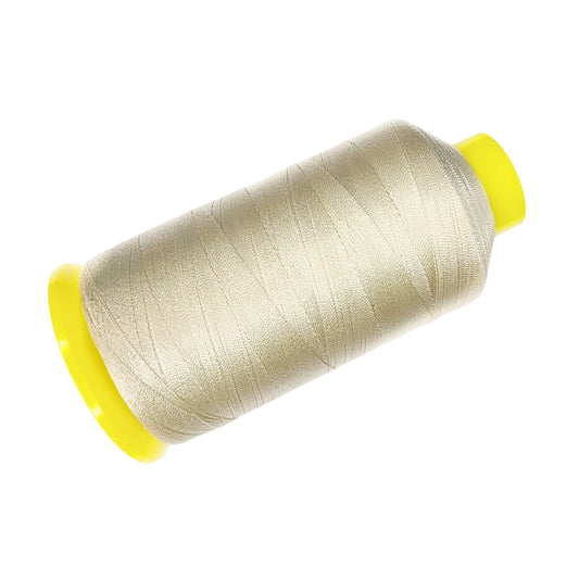 Spool of blonde thread with yellow ends on a white background