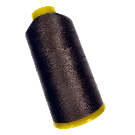 Spool of dark brown thread with yellow ends on a white background