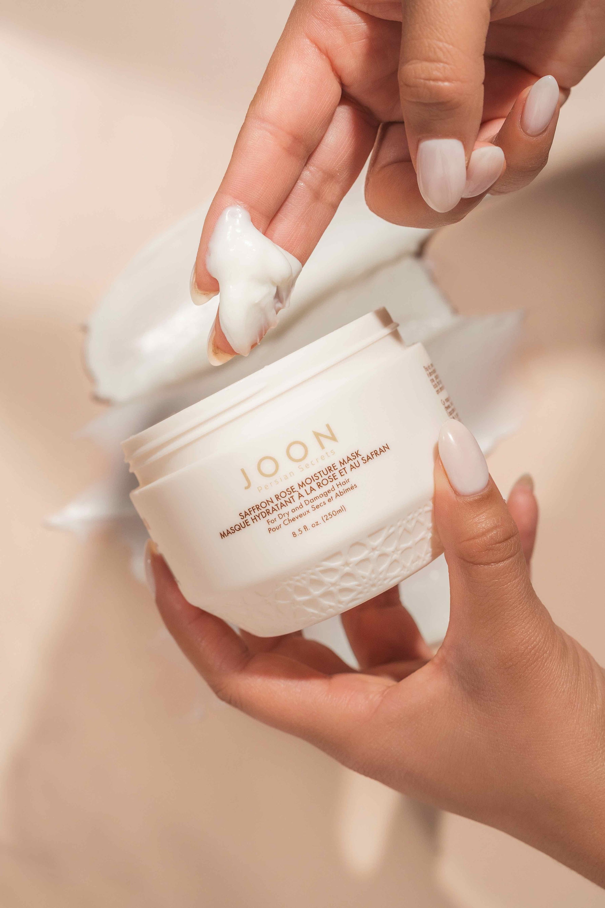 Moisture Mask being applied to model's fingers.