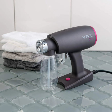 Lifestyle image of the Norvell Oasis Portable Spray Tan Gun. 