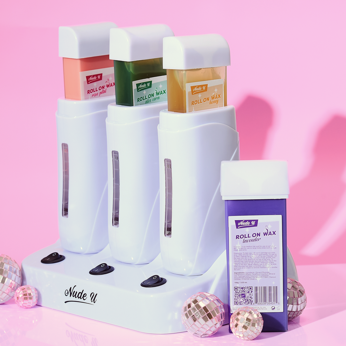 Lifestyle image of all four NudeU roll-on waxes with the NudeU triple roll-on wax warmer.
