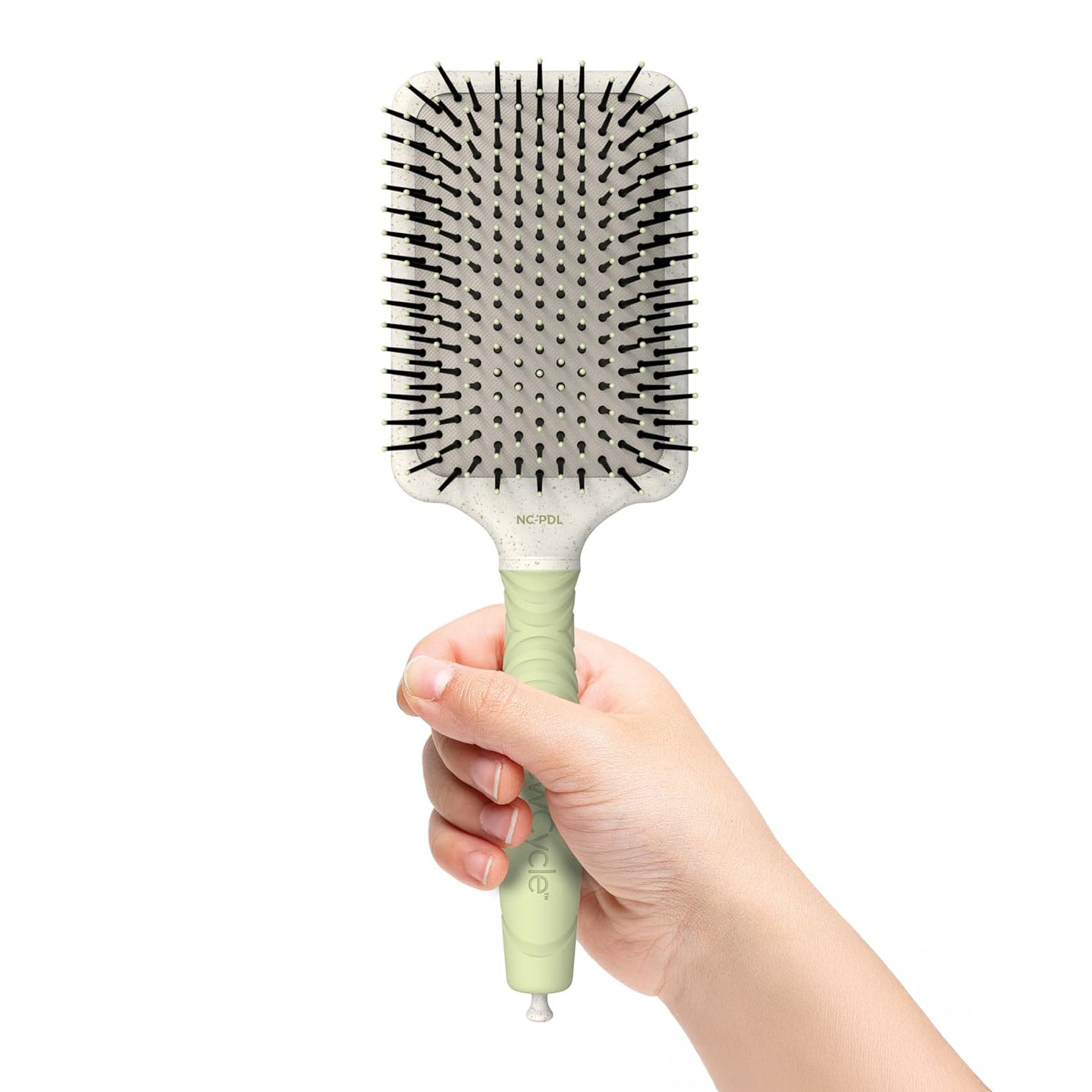 A model holds the Olivia Garden Large paddle brush. 