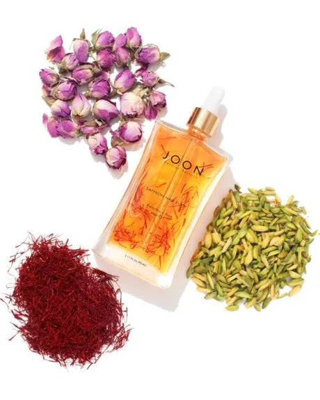 Image of Joon Saffron Hair Elixir amongst the key ingredients of saffron, pistachio, and rose.