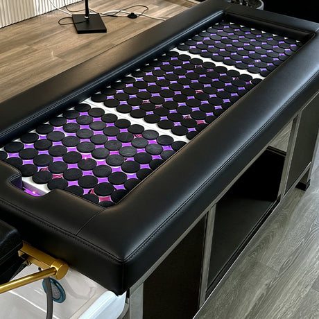 Detail image of the hot stones on the black SSW 611-2D Fresh Water Japanese Head Spa Massage Bed. 