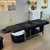 Lifestyle image of the black SSW 611-2D Fresh Water Japanese Head Spa Massage Bed in a salon.
