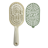 Image of the ivory and green SSW Flexible Self-Cleaning Detangling Hairbrush separated from the hair removal plate.