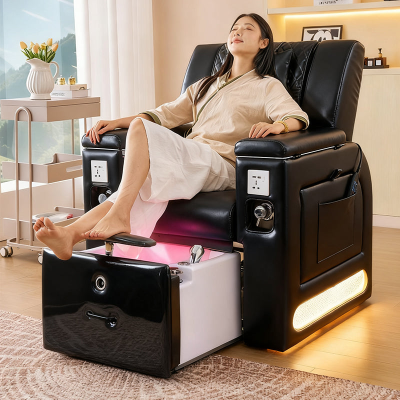 Model using the footrest on the black SSW M30 Manicure-Pedicure Spa Chair. 