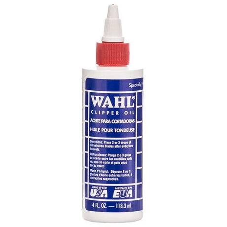 Bottle of Wahl Clipper Oil with a red cap, labeled for lubricating electric clippers, 4 fl.oz. size.